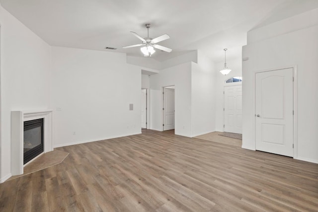 unfurnished living room with ceiling fan and hardwood / wood-style flooring