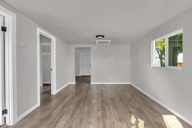 spare room featuring dark wood-type flooring