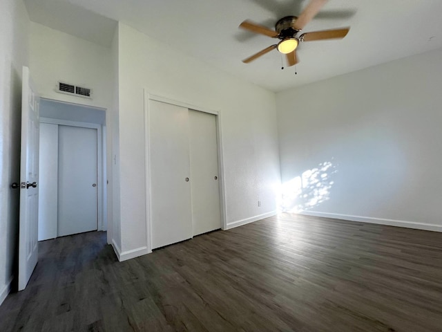 unfurnished bedroom with ceiling fan, a closet, and dark hardwood / wood-style floors