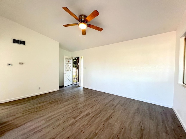 empty room with lofted ceiling, dark wood-type flooring, and ceiling fan