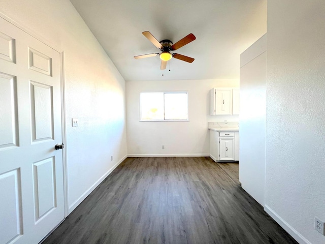 spare room with ceiling fan and dark wood-type flooring