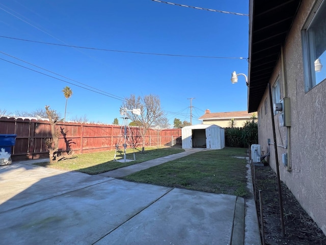 view of yard featuring a patio and a storage unit