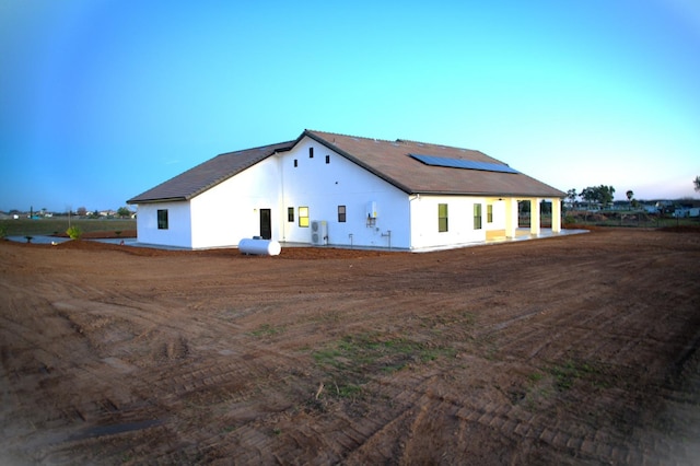 back of house with solar panels