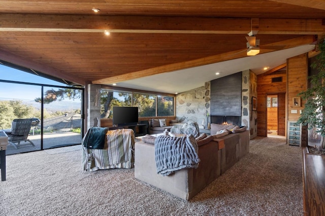 living room featuring carpet flooring, ceiling fan, an outdoor stone fireplace, lofted ceiling with beams, and wood ceiling