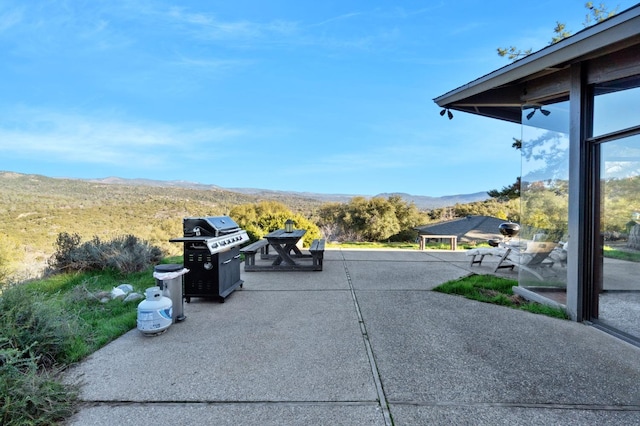 view of patio / terrace with area for grilling and a mountain view