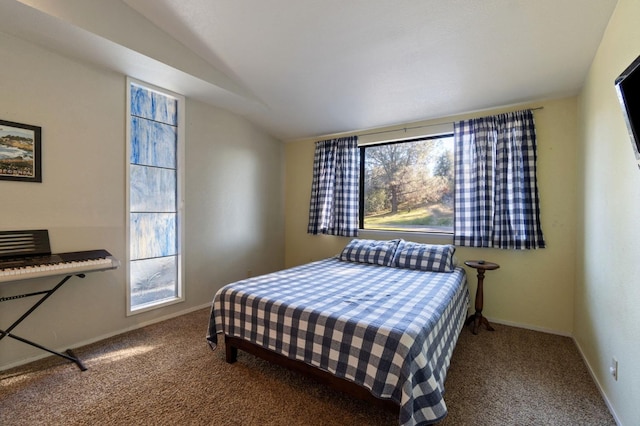 bedroom with carpet floors and lofted ceiling