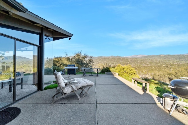 view of patio featuring a mountain view and area for grilling