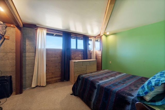 carpeted bedroom featuring beam ceiling