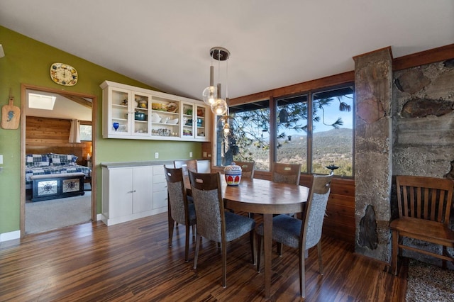 dining area featuring dark wood-type flooring and lofted ceiling