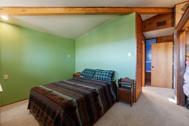 bedroom with light colored carpet and lofted ceiling with beams