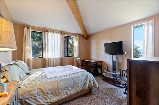 carpeted bedroom with multiple windows and beamed ceiling