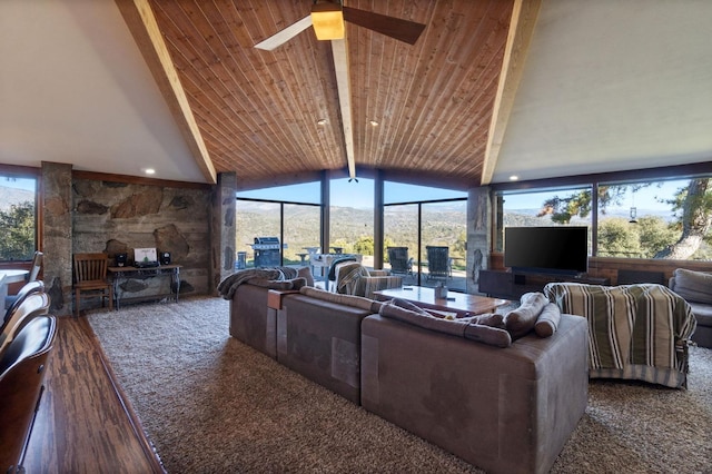 living room featuring lofted ceiling with beams, ceiling fan, a healthy amount of sunlight, and wood ceiling