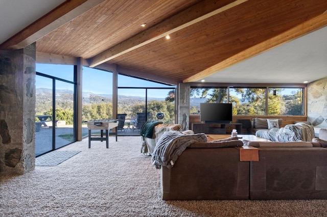 carpeted living room with a healthy amount of sunlight, wooden ceiling, and vaulted ceiling with beams