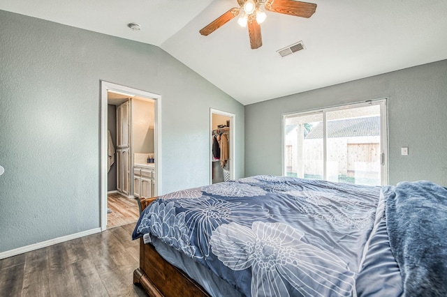 bedroom featuring a spacious closet, lofted ceiling, ceiling fan, wood-type flooring, and a closet