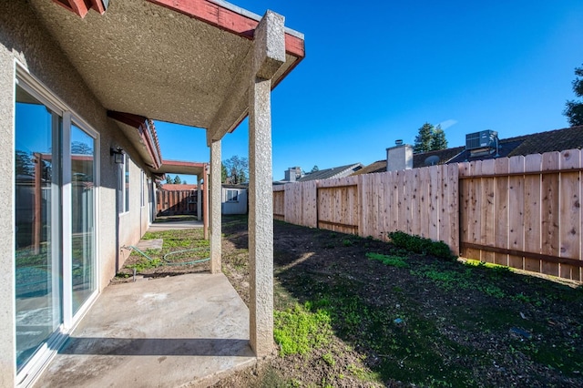 view of yard featuring a patio, a shed, central AC, and a fenced backyard