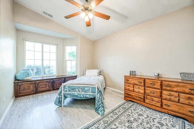 bedroom with lofted ceiling, visible vents, light wood-style flooring, and baseboards