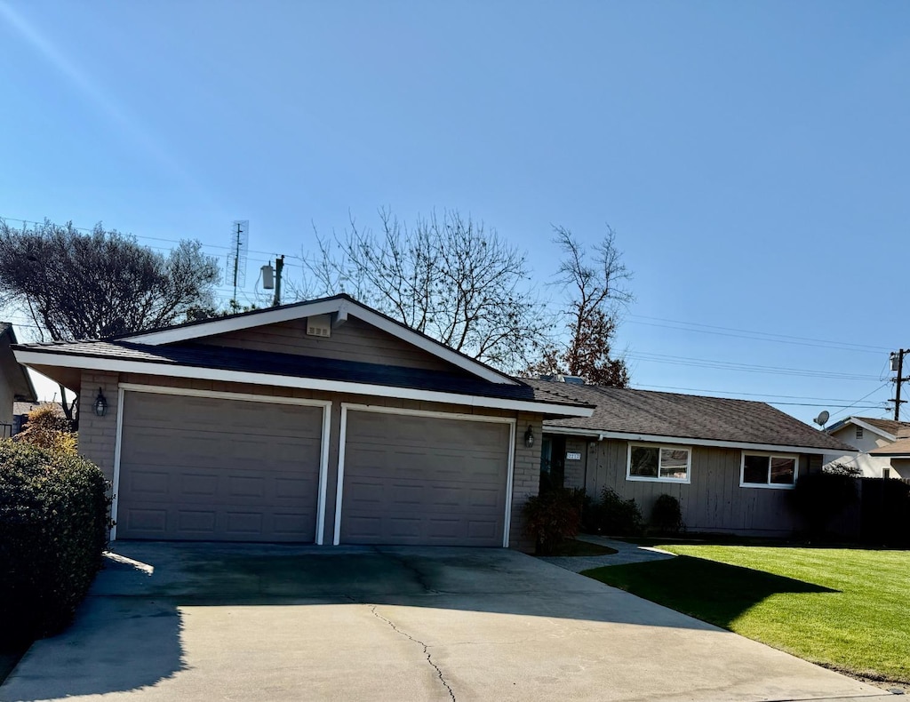 ranch-style home with a front yard and a garage