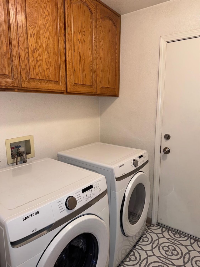 laundry room featuring washer and dryer and cabinet space