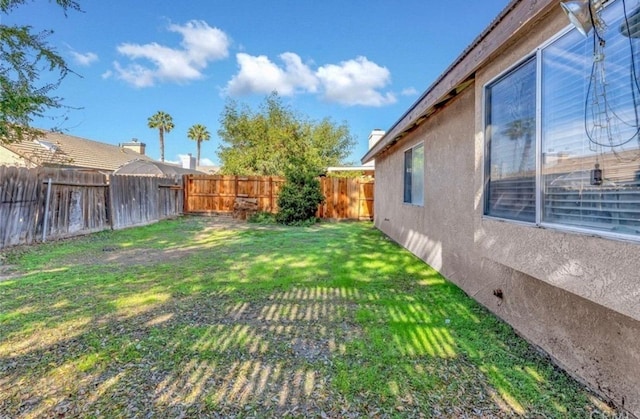 view of yard with a fenced backyard