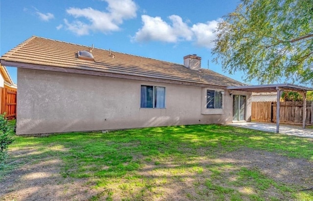 back of house featuring a patio, a lawn, a fenced backyard, and stucco siding