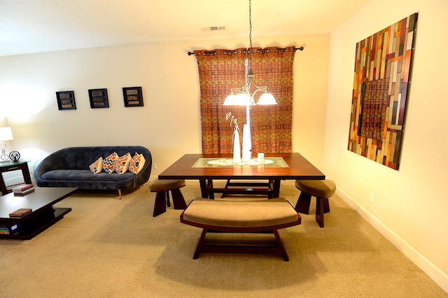 dining area featuring a notable chandelier and carpet flooring