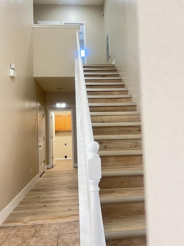 stairway with tile patterned floors