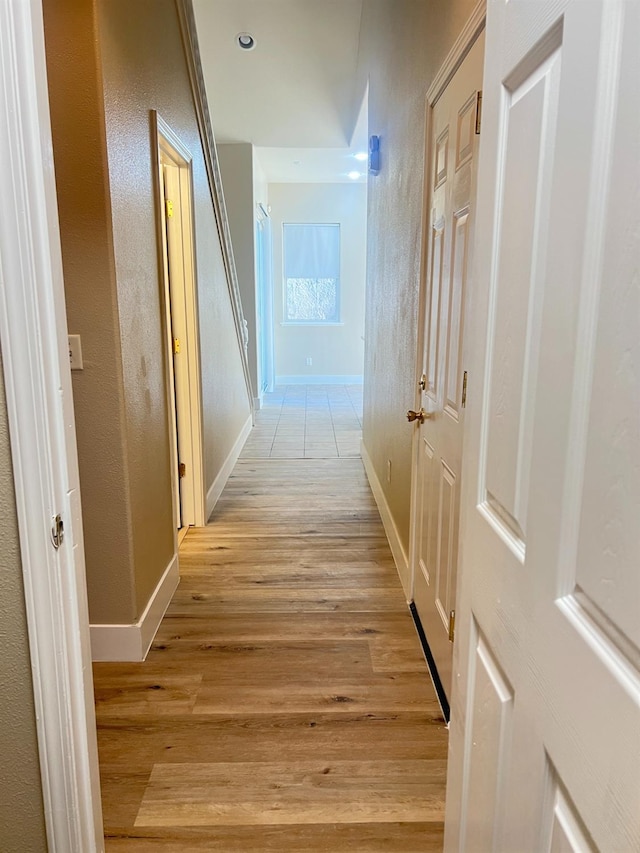 corridor with light hardwood / wood-style floors