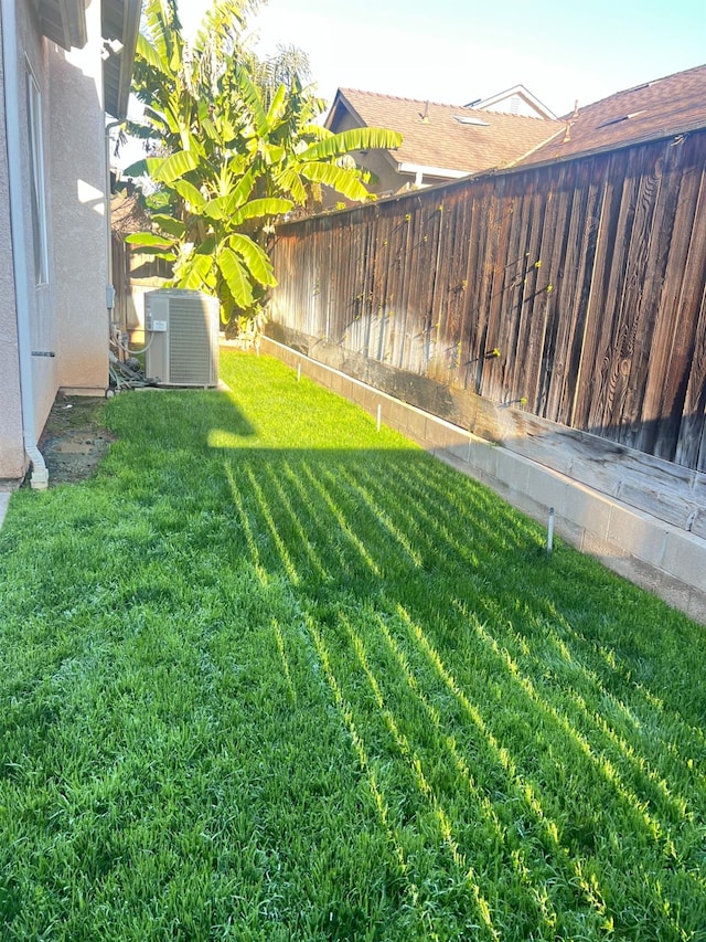 view of yard with central AC