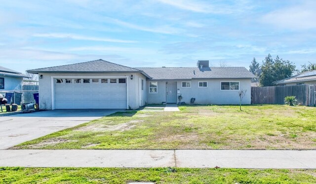 ranch-style house with a garage and a front lawn