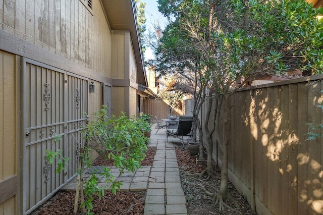 view of side of home featuring a patio area and a fenced backyard