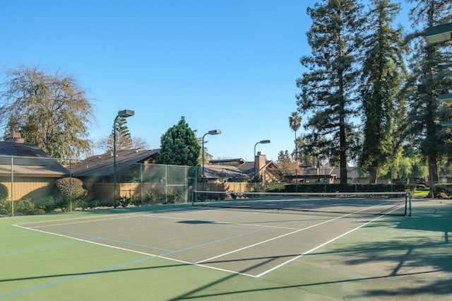 view of tennis court with fence