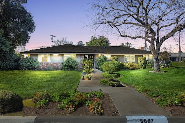 ranch-style house with a yard