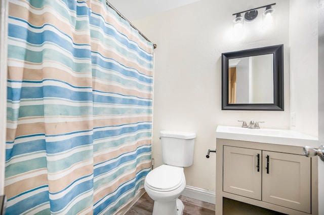 bathroom with a shower with curtain, hardwood / wood-style floors, vanity, and toilet