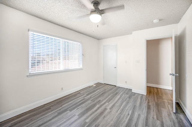 unfurnished bedroom featuring a closet, a textured ceiling, ceiling fan, and light wood-type flooring