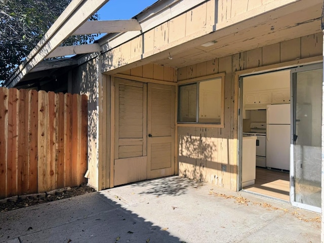 view of exterior entry featuring a patio