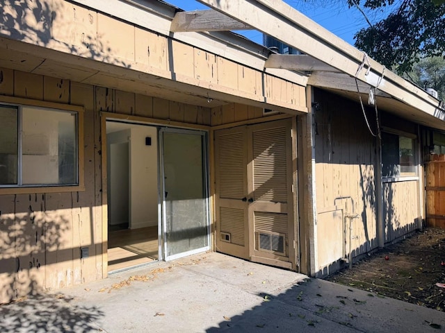 view of exterior entry featuring a patio