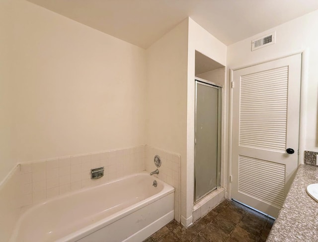 bathroom with vanity and independent shower and bath