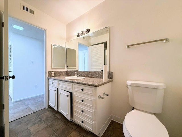 bathroom with toilet and vanity