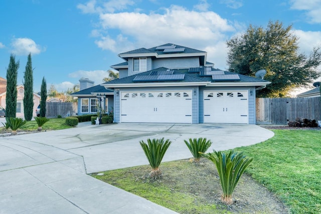 view of property with solar panels, a front yard, and a garage