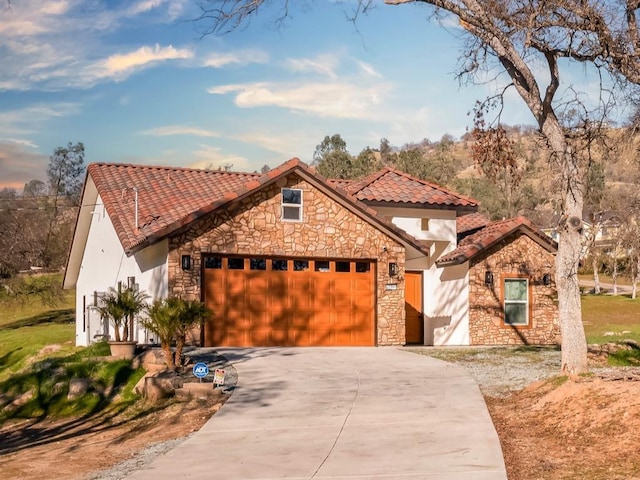 mediterranean / spanish home featuring a garage