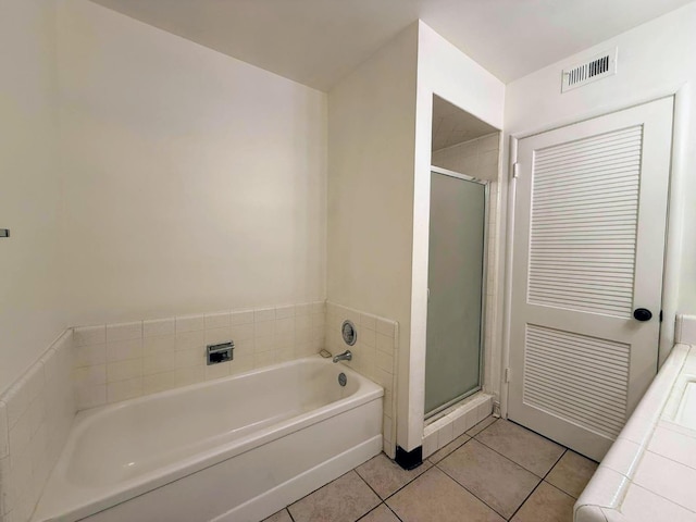 bathroom featuring tile patterned floors and shower with separate bathtub