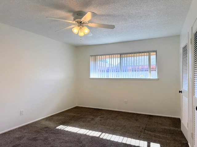 carpeted spare room with a textured ceiling and ceiling fan