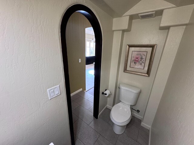 bathroom featuring toilet and tile patterned floors