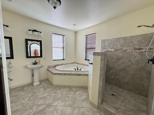 bathroom featuring independent shower and bath, tile patterned flooring, and a textured ceiling