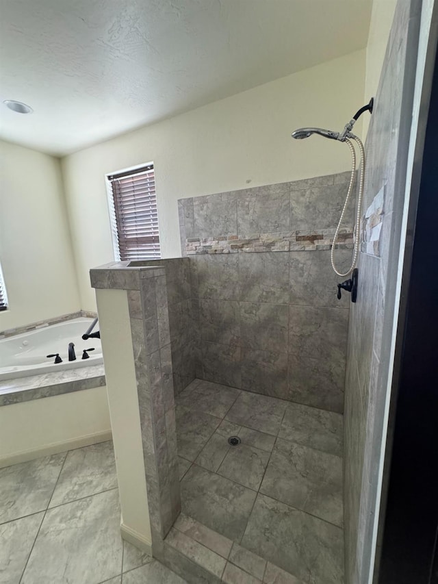 bathroom featuring tile patterned floors and separate shower and tub