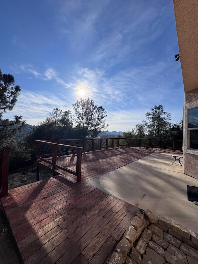 wooden terrace featuring a patio area