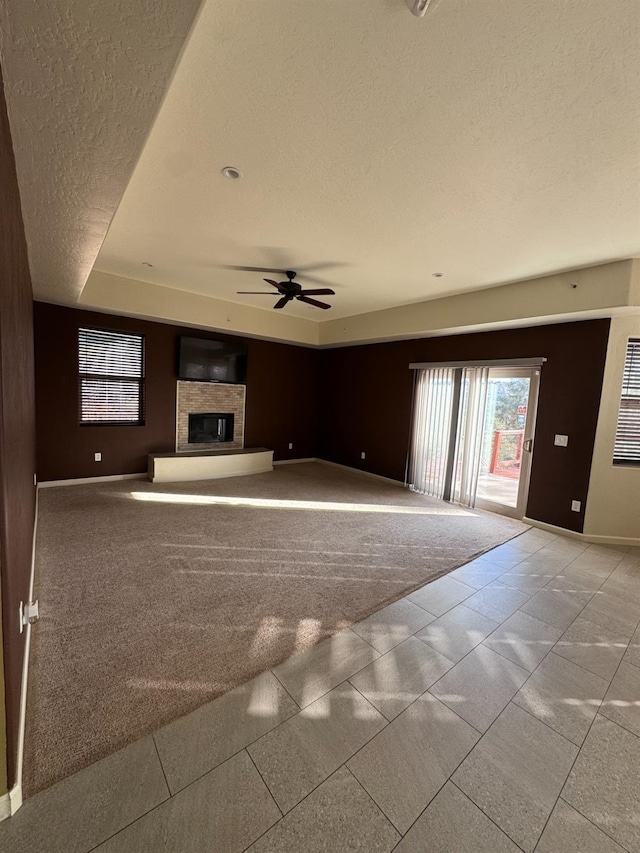 unfurnished living room featuring a textured ceiling and ceiling fan