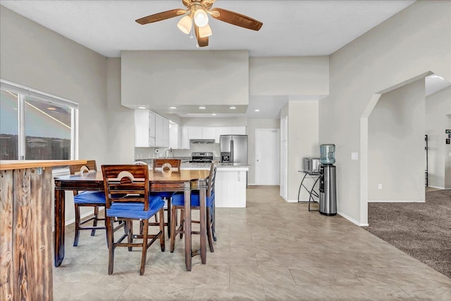 carpeted dining area featuring ceiling fan