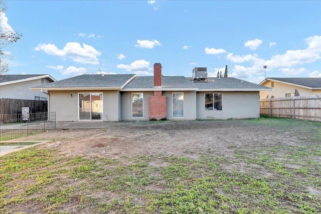 rear view of property with central AC and a patio