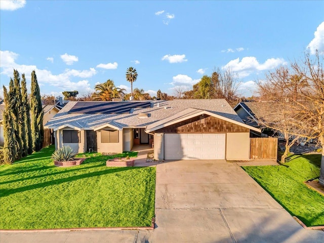 ranch-style house featuring a front yard and a garage